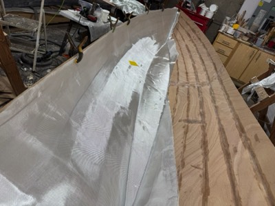  3/4/25 - Fiberglass cloth is laid on half the interior. 