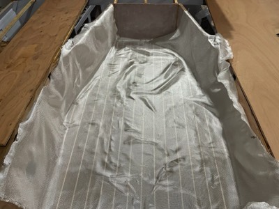  6/10/21 - Fiberglass cloth is laid on the cockpit sole. 