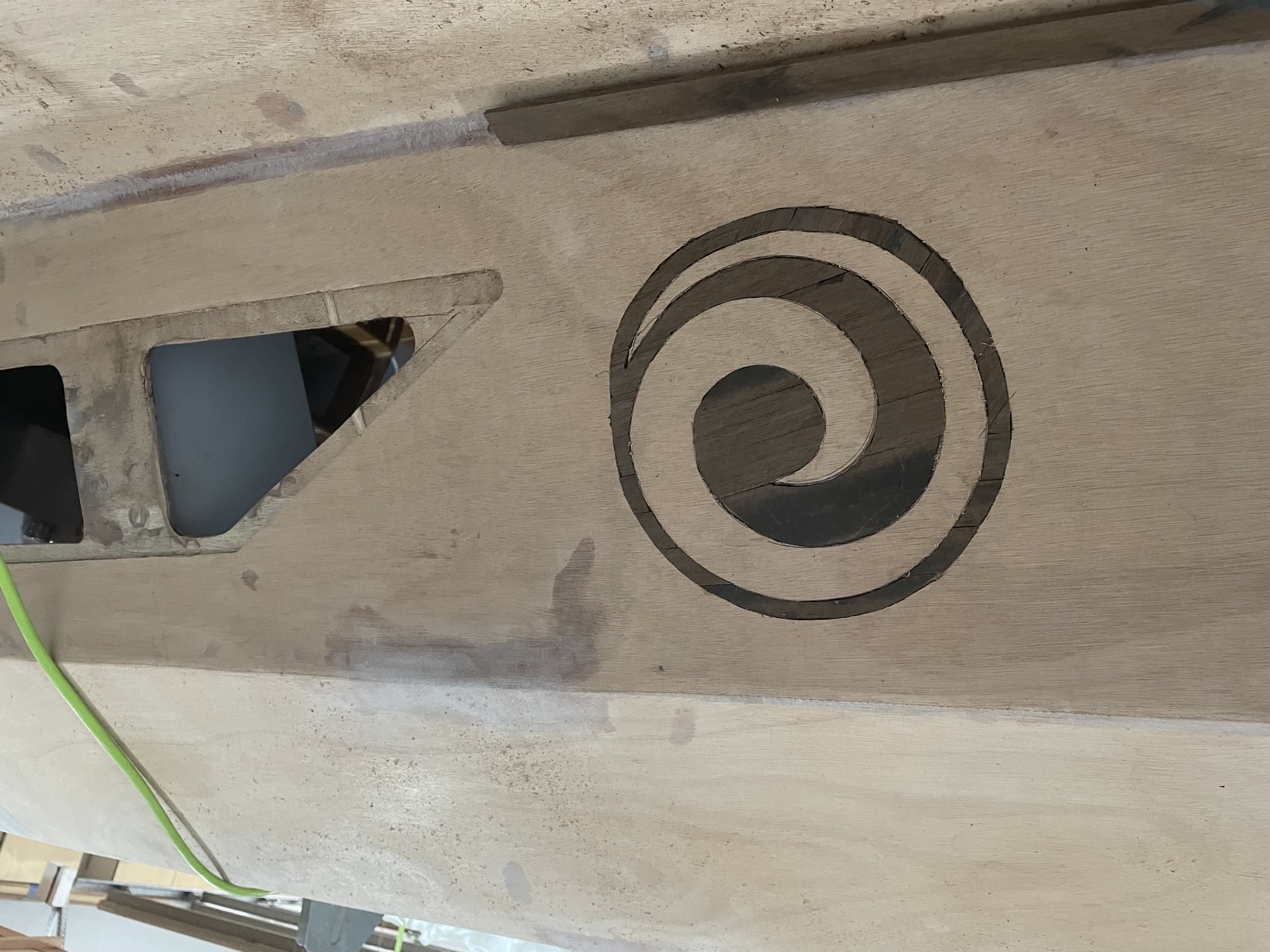  7/15/21 - Walnut Koru inlay is cut into the side of the cabin. 